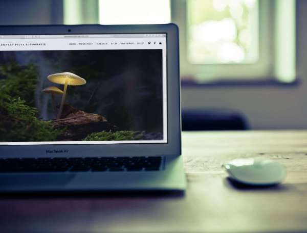Schreibtisch mit Mouse und MacBook Air mit geöffneter Responsive Website von Lennert Piltz Fotografie aus Spremberg